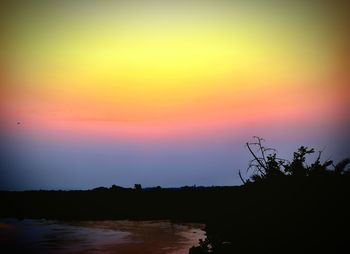 Scenic view of silhouette landscape against romantic sky at sunset