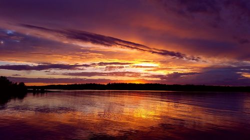 Scenic view of lake against romantic sky at sunset