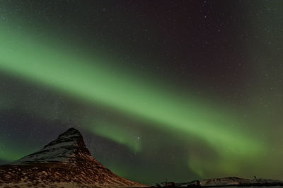 Low angle view of aurora borealis at night during winter