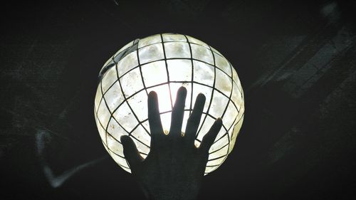 Low angle view of illuminated lights at night
