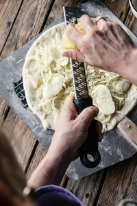 Cropped hand of person preparing food