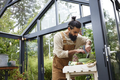 Man gardening in greenhouse