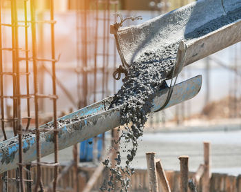 Pouring concrete mix to structure building in construction site