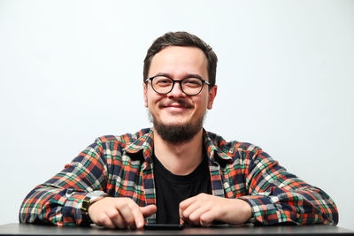 Portrait of young man against white background
