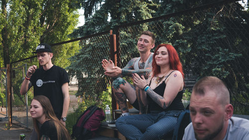 Portrait of young couple sitting outdoors