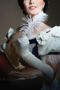 Midsection of woman holding flower