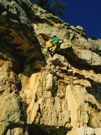 Rear view of man climbing mountain