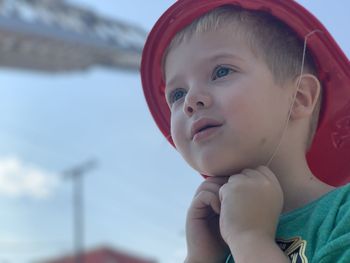 Cute boy looking away while wearing hat