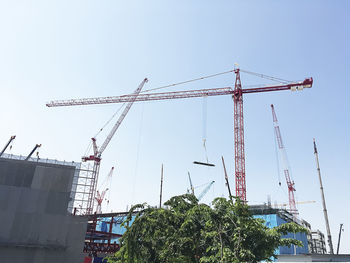 Low angle view of crane against clear sky