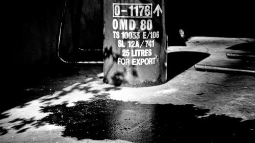 Close-up of information sign on wet street