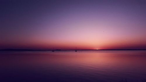 Scenic view of sea against romantic sky at sunset