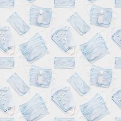 Top view on blue protective medical masks, sanitizer gel. photo seamless pattern of medical masks. 