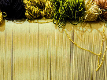 Close-up of various silk threads on loom in carpet factory