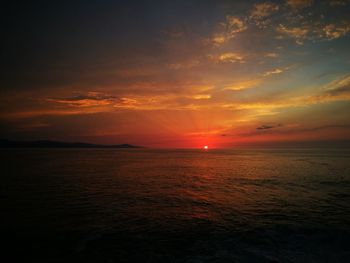 Scenic view of sea against romantic sky at sunset