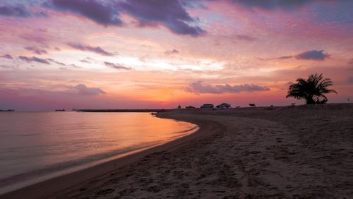 Scenic view of beach against sky during sunset