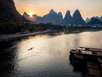 Scenic view of river against sky during sunset