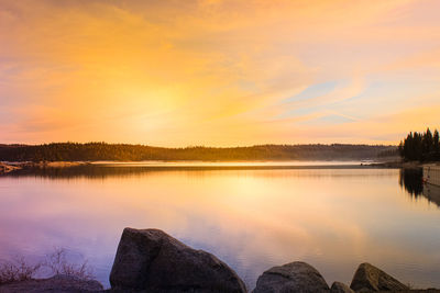 Scenic view of lake against sky during sunset