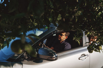 Man looking at the road through the car window