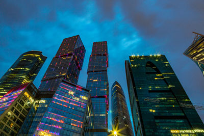 Low angle view of illuminated buildings against sky at night