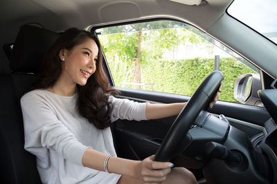 Portrait of woman sitting in car