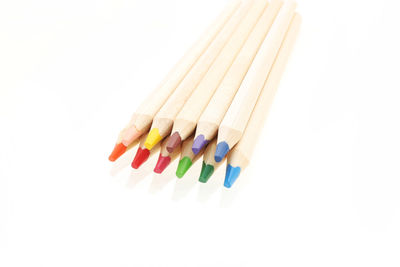 Close-up of multi colored pencils against white background