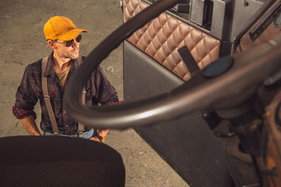 Handsome man standing outside truck