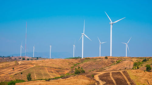 Windmill on field against sky