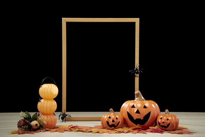 Close-up of pumpkin on table against black background