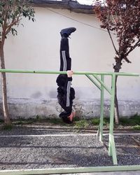 Side view of woman standing against trees