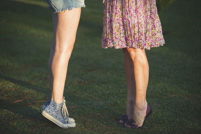 Low section of woman standing on grass