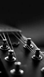 Close-up of guitar over black background