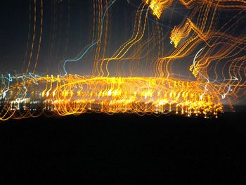 Close-up of illuminated fireworks against sky at night