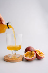 Hand holding drink against white background