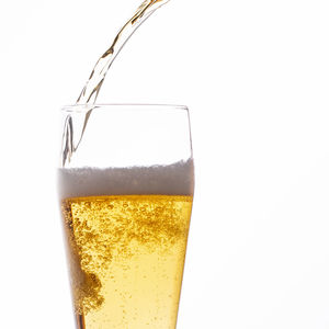 Close-up of beer glass against white background