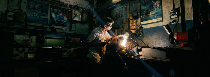 Cropped image of man welding metal