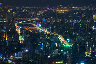 High angle view of illuminated city buildings at night