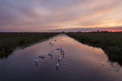 Scenic view of lake against sky during sunset