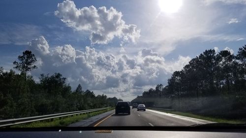 Cars on road against sky