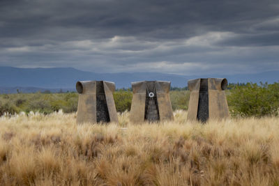 Old ruins on field against sky