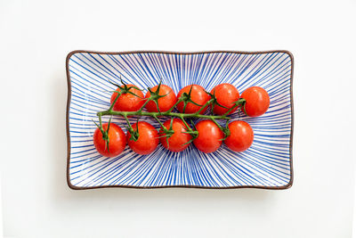 High angle view of fruits on table against white background