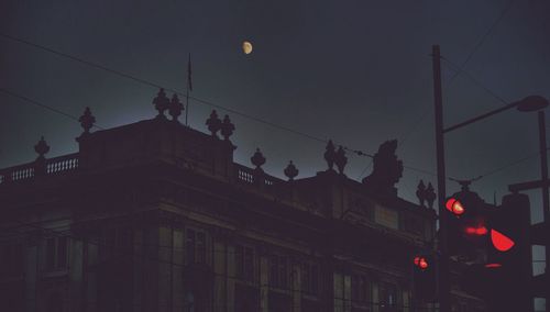 Low angle view of illuminated street light against sky