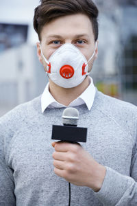 Midsection of man drinking coffee