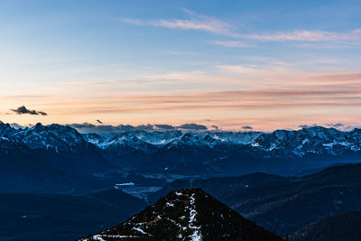 Scenic view of snowcapped mountains against sky during sunset