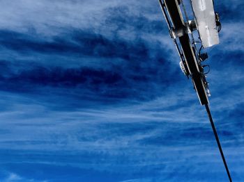 Low angle view of telephone pole against blue sky