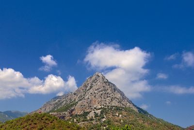 Low angle view of mountain against blue sky