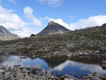 Scenic view of lake and mountains against sky