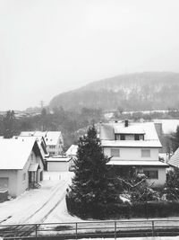 Houses and trees against sky