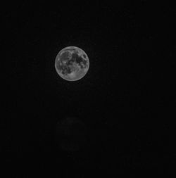 Low angle view of moon against sky at night