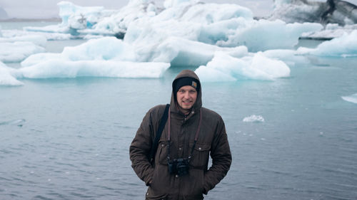 Young woman standing in sea during winter