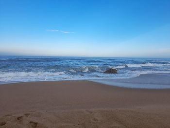 Scenic view of beach against sky during sunset